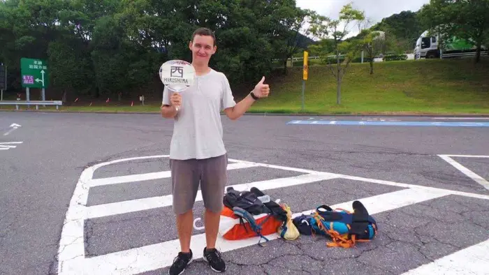 Jake hitchhiking in Japan