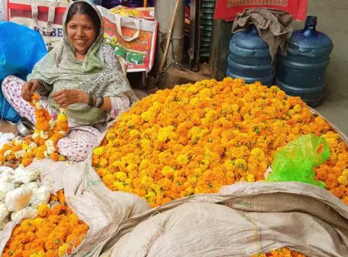 Woman making flower necklaces in Delhi, India