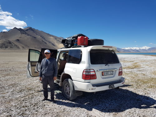 Driver and car along the Pamir highway - Tajikistan