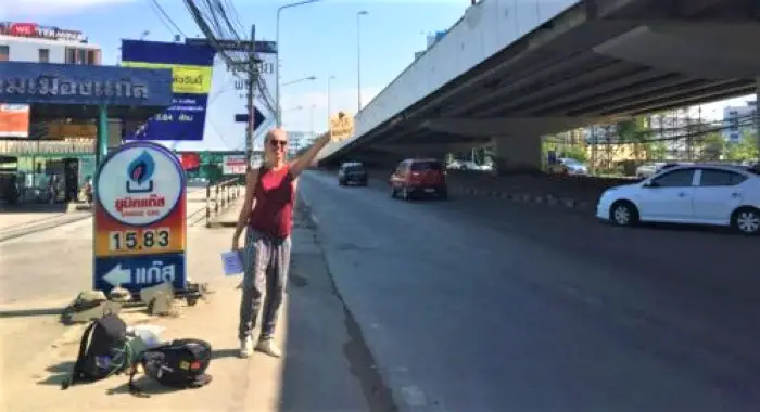 Hitchhiking by the road in Thailand