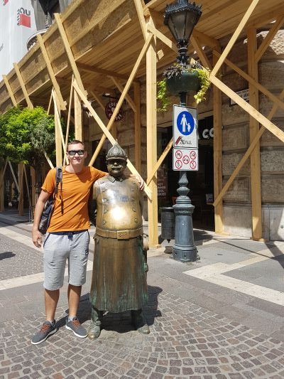 Jake posing with a statue in Budapest, Hungary