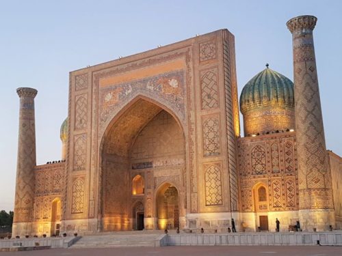 Registan Square lit up at night in Samarkand, Uzbekistan