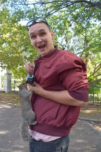 Jake feeding a squirrel in the park - Cape Town