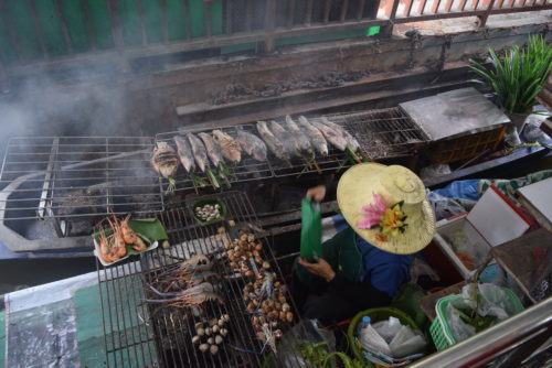 A local making food on a boat