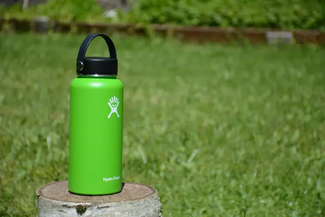 A green flask on a wood slab